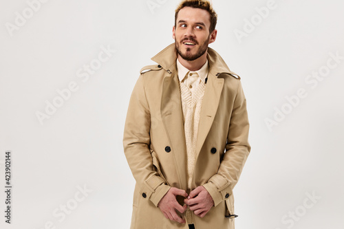 man in beige coat emotions studio modern style isolated background
