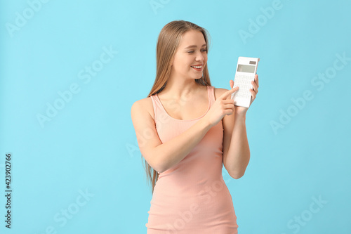 Young woman with calculator...