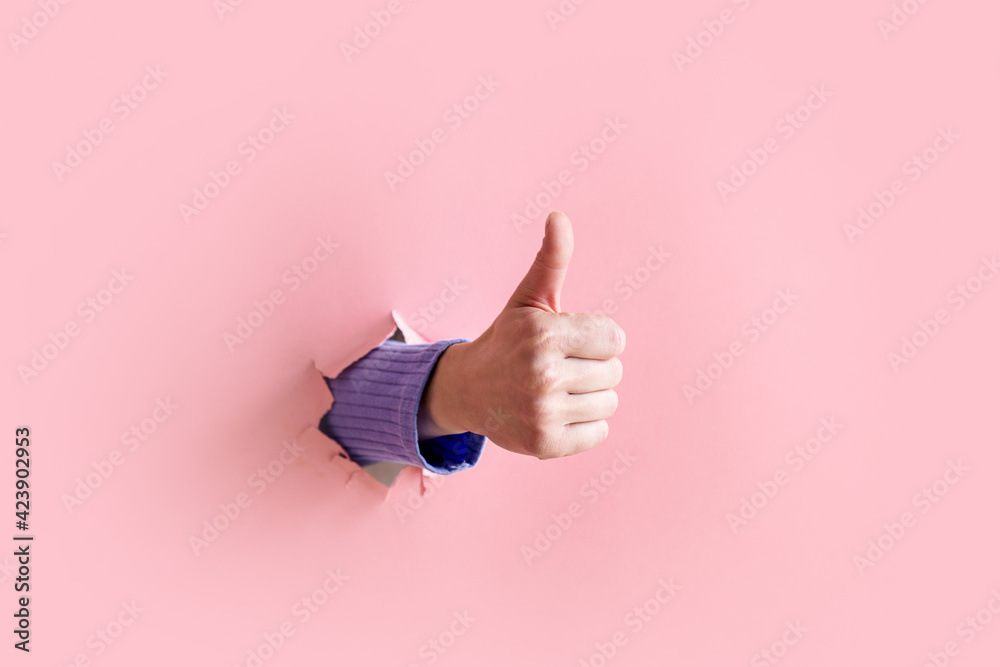 woman hand show good gesture on pink background.