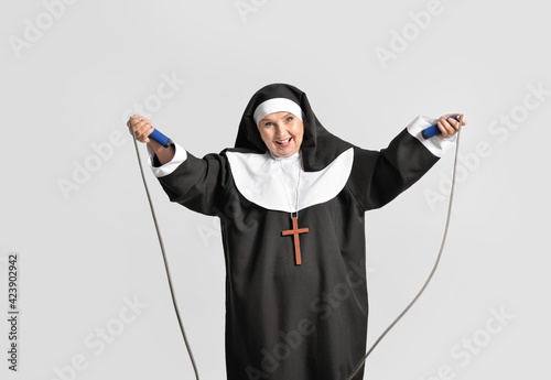 Senior nun with jumping rop...