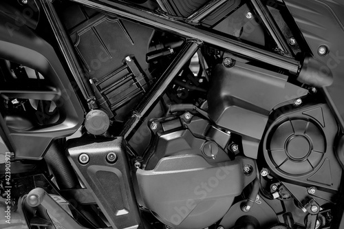 Close-up engine part of modern motorcycle on black color, background