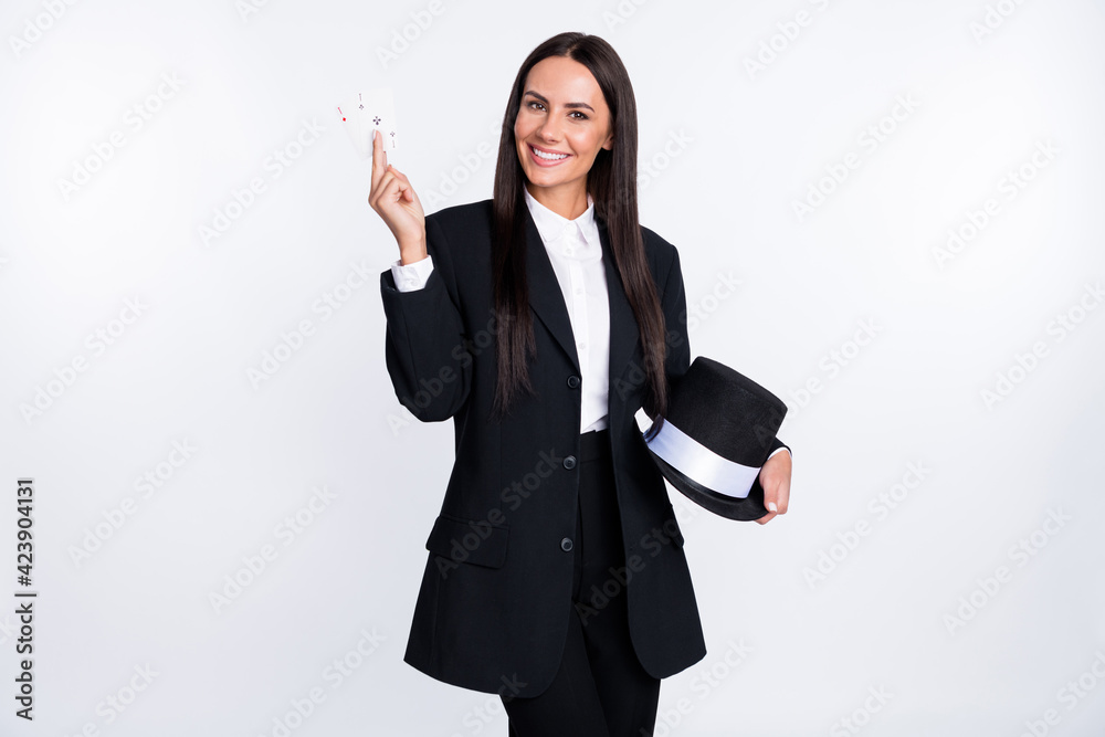 Photo of young beautiful smiling girl illusionist showing two cards trick mystery isolated on white color background Photo of young beautiful smiling girl illusionist showing two cards trick mystery isolated on white color background