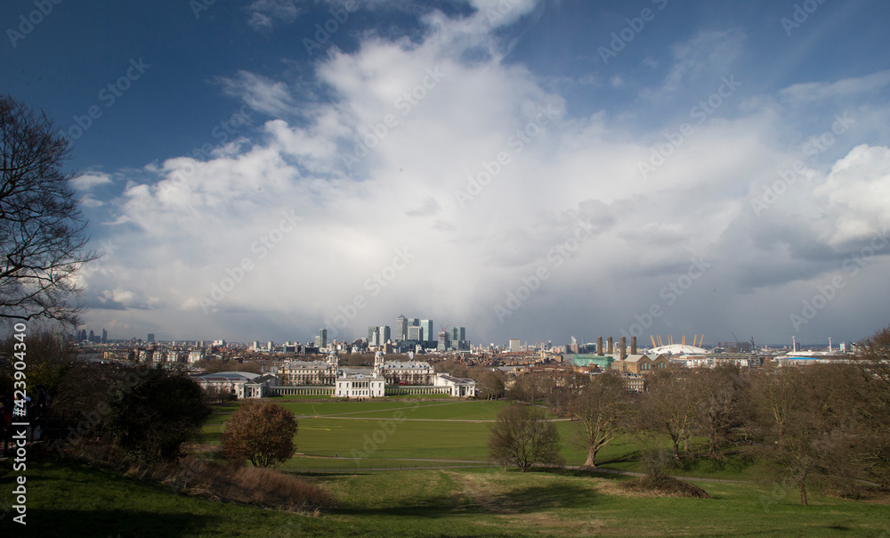 View of the City of London including the Millenium Dome and Canary Wharf from Greenwich Park, London, England, UK.