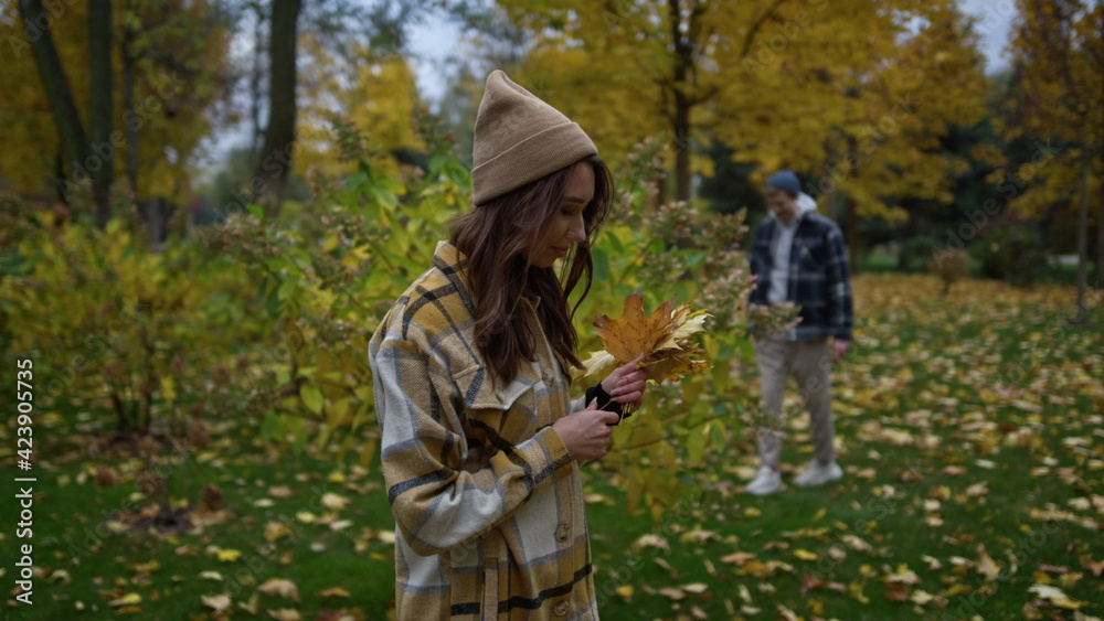 Close up view of dreaming stylish girl in plaid shirt and had holding leaves. Close up view of dreaming stylish girl in plaid shirt and had holding leaves.