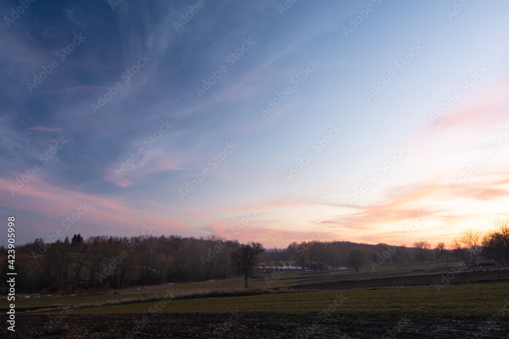 Rural landscape. Sunset over the field in spring