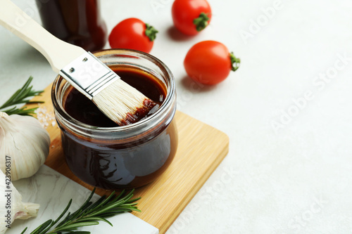Slika na platnu Concept of cooking with barbecue sauce on white textured table