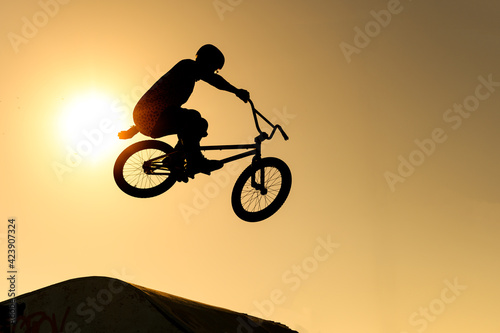 silhouette of a biker in the air