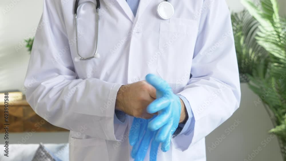A Doctor in a White Coat Puts on Rubber Gloves against the Virus during a Pandemic, Safety Is A Health Concept A Doctor in a White Coat Puts on Rubber Gloves against the Virus during a Pandemic, Safety Is A Health Concept