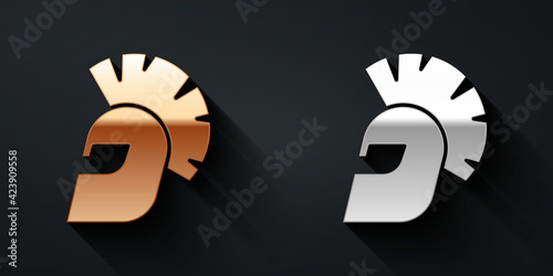 Gold and silver Greek helmet icon isolated on black background. Antiques helmet for head protection soldiers with a crest of feathers or horsehair. Long shadow style. Vector