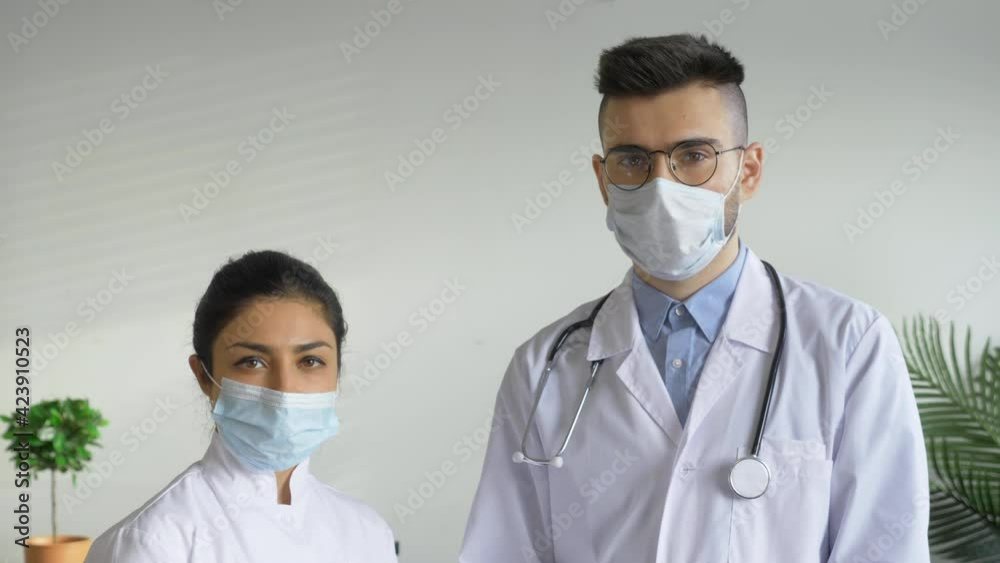 Portrait Two Doctors A Man and a Woman Looking at the Camera Are in a Bright room in the Hospital Portrait Two Doctors A Man and a Woman Looking at the Camera Are in a Bright room in the Hospital