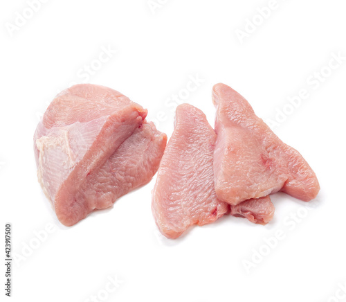 Fresh turkey fillet. Cut into slices. White background. Isolated. Close-up. View from above.