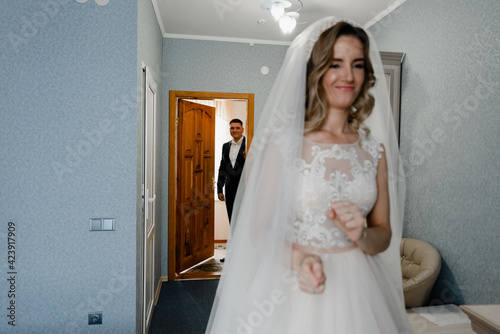 the first meeting of the groom with the bride on the wedding day. the groom takes the bride out of the house. first glances of the newlyweds. wedding couple together again.