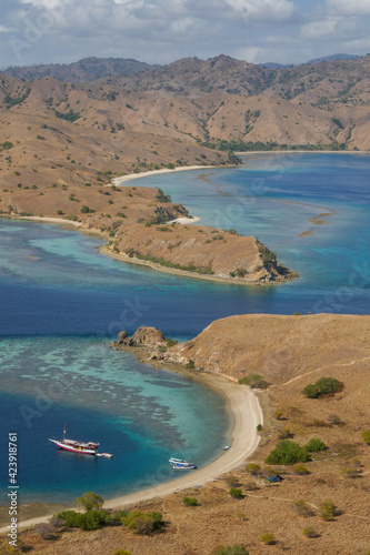 Colorful landscape view of the narrow strait between Gili Lawa Darat island and Komodo island in the background, Flores, East Nusa Tenggara, Indonesia