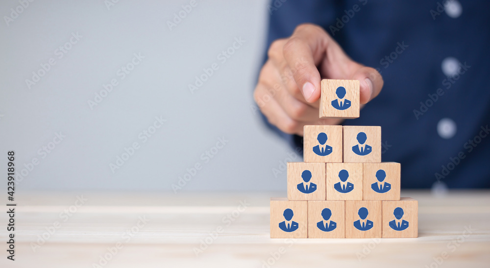 Concept of human resource management and recruitment business Hand put wood cube block on top pyramid To business success concept. - obrazy, fototapety, plakaty 