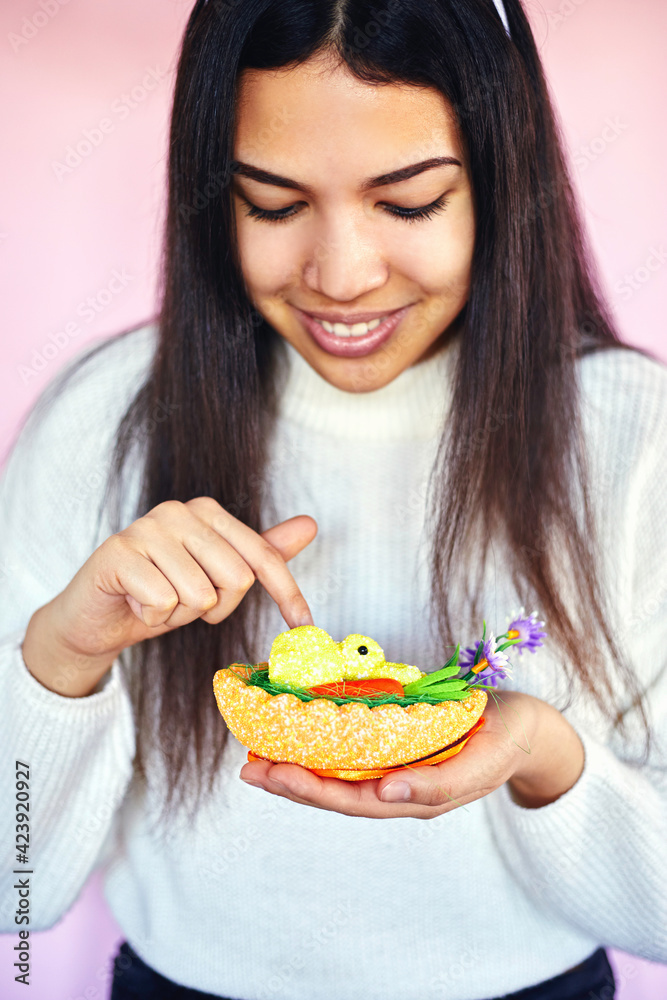 Young happy woman holding Easter egg and bunny on pink background. Happy Easter. Holiday concept. Young happy woman holding Easter egg and bunny on pink background. Happy Easter. Holiday concept.
