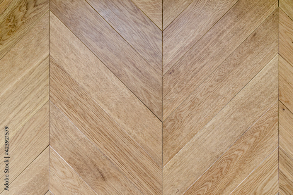Top view of an french herringbone parquet floor under natural light. Wooden pattern with oak diagonal texture. - obrazy, fototapety, plakaty 
