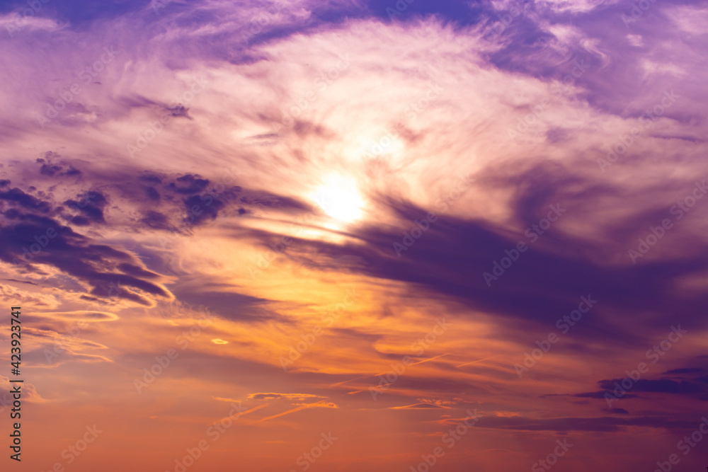 Orange lilac sunset sky with feather clouds. Backdrop background for design
