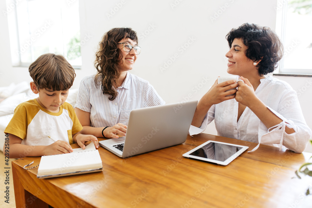 Couple at home with son studying