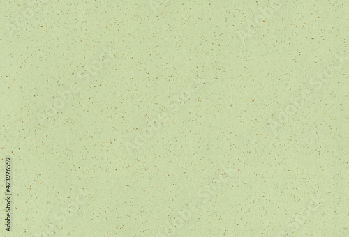 Recycled beige, light green paper background with inclusions of small natural fibers. Extra large highly detailed image.