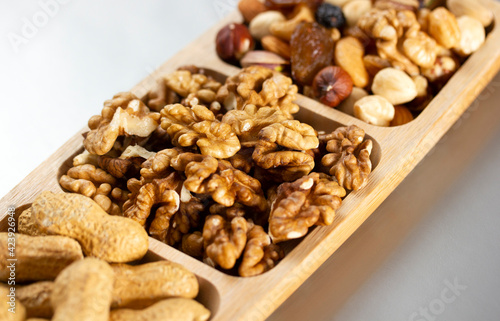 Mixed nuts in a bamboo plate. Healthy food concept.