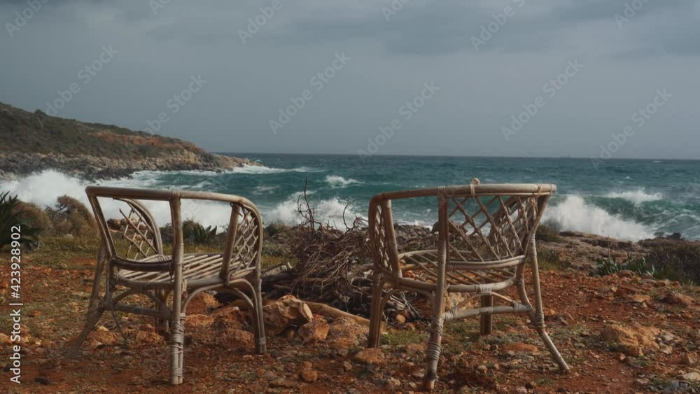 Two Wooden Chairs And Fireplace In Front Of The Ocean, Peloponnes, Greece Two Wooden Chairs And Fireplace In Front Of The Ocean, Peloponnes, Greece