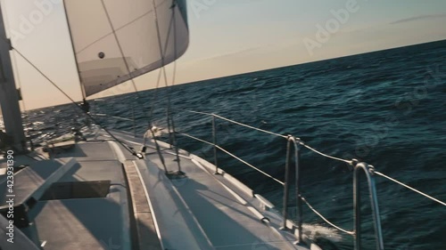 Breathtaking view of ocea water near yacht board. Water splashes making white foam. Yacht sailing in ocean.