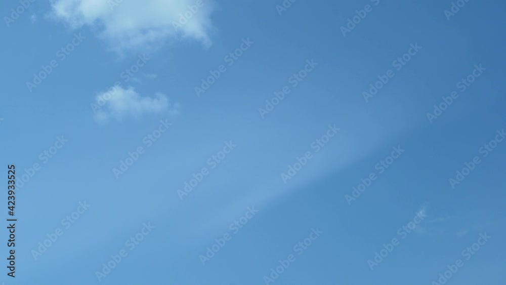 A White Puffy Cloud Flies Away Dissolving Clearing The Clear Blue Azure Sky on A Sunny Cloudy Day, Timelapse. Background of White Cumulus Fluffy Clouds and Blue Sky. Good Weather, Clean Air Atmosphere A White Puffy Cloud Flies Away Dissolving Clearing The Clear Blue Azure Sky on A Sunny Cloudy Day, Timelapse. Background of White Cumulus Fluffy Clouds and Blue Sky. Good Weather, Clean Air Atmosphere
