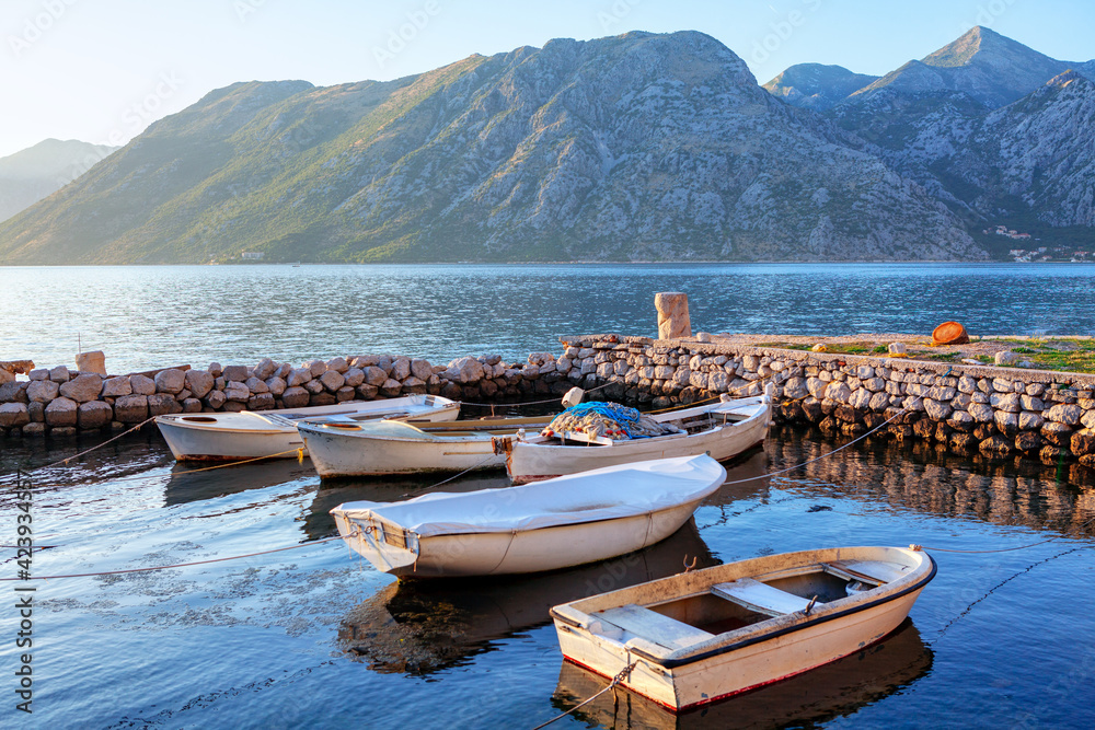 White wooden boats for fishing on the harbour . Morning Outlook of Mountains and Lagoon 