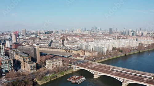 Aerial drone shot over Chelsea Grosvenor rail bridge towards central London photo