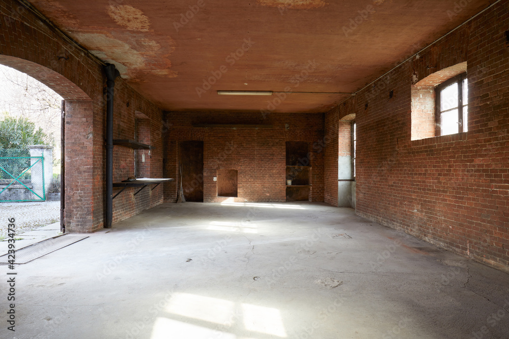Old, empty workshop interior with brick walls