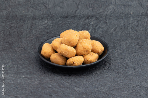 Indian Subcontinental Mathura Peda Or Pede Offered As Prasad To Hindu God Is Auspicious Mithai Made Of Mawa Khoya Makhan Meetha Gud Doodh Khoa Malai Mava Gur Served In Plate On Black Background