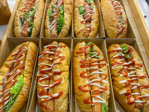 Hot dog sandwiches fully loaded with assorted toppings for sale