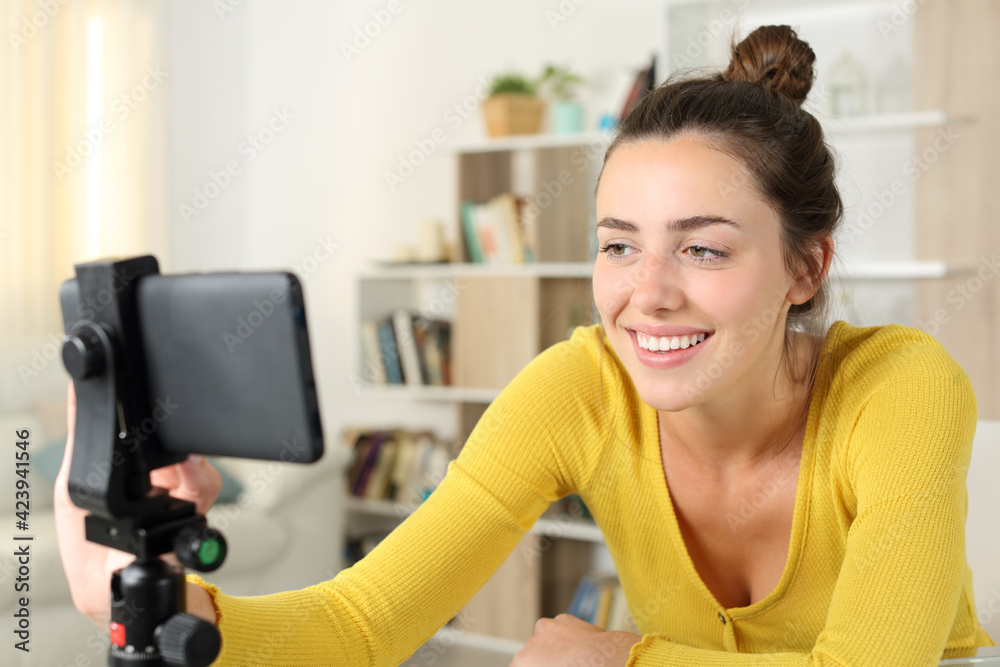 Happy woman checking smart phone content at home