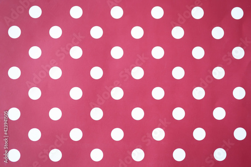 Red background with white circles. Polka dot closeup