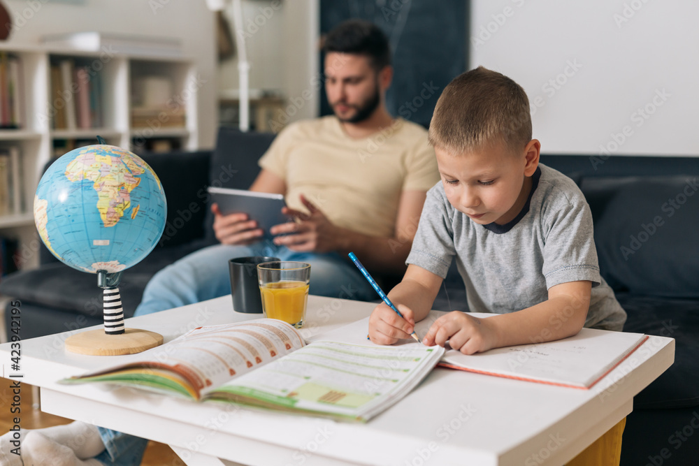 Naklejka premium father helping his son to do homework