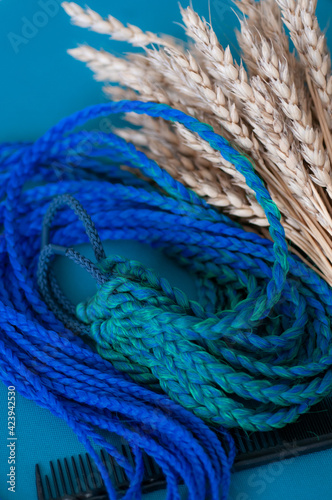 Fototapeta Naklejka Na Ścianę i Meble -  Hair accessory elastic band with blue-green braids