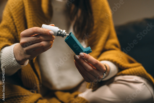 close up woman using asthma pump photo