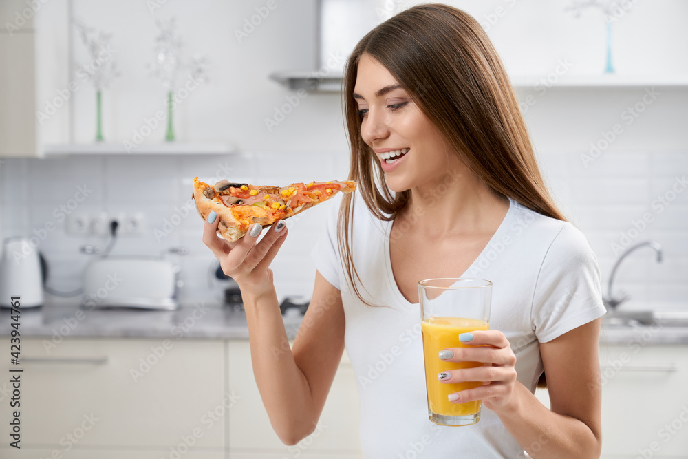 Beautiful brunette eating pizza and drinking juice. Beautiful brunette eating pizza and drinking juice.