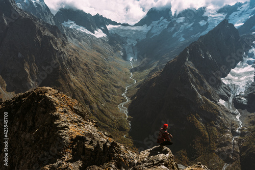 Traveler in the mountains. A man enjoys a beautiful view of the mountains. Man on the background of mountains. Man at sunrise in the mountains. A man is traveling in the Caucasus. Copy space