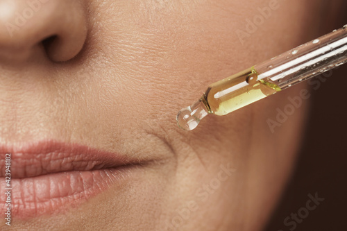 Cuadro en lienzo Female face and dropper with rejuvenating serum