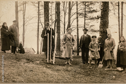Latvia - CIRCA 1930s: People planting trees. Group photo in forest. Vintage archive Art deco era photo photo