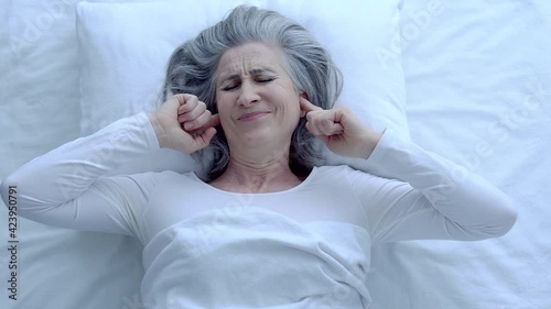 Wallpaper Mural Upset middle-aged female covering ears, trying to rest with noise, discomfort Torontodigital.ca