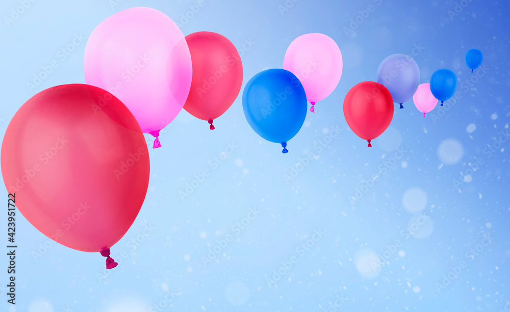 multicolored flying helium balloons on a blue background