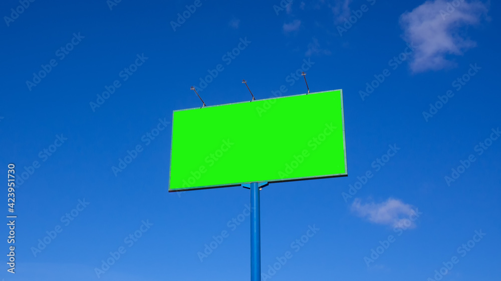 Green screen. Billboard over blue sky with clouds. Green screen. Billboard over blue sky with clouds.
