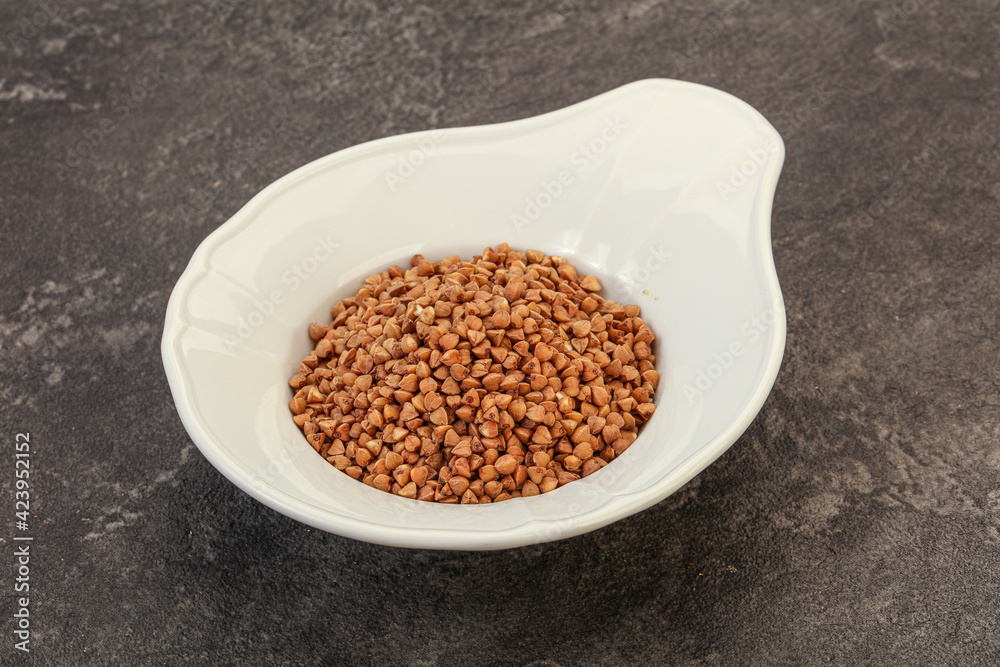 Raw buсkwheat cereal in the bowl Raw buсkwheat cereal in the bowl