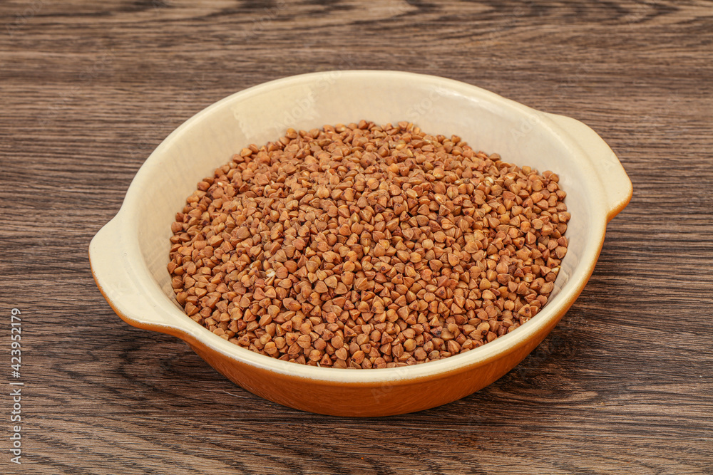Raw buсkwheat cereal in the bowl Raw buсkwheat cereal in the bowl