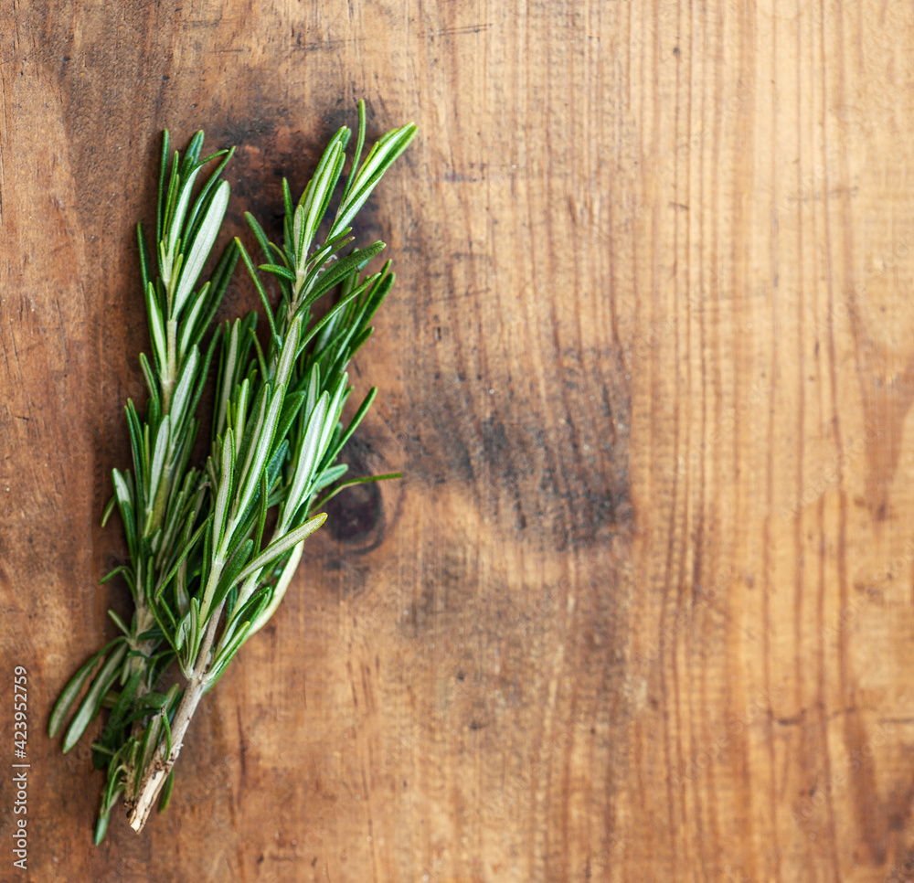 Fresh rosemary herb on wooden background. Top view rosemary with copy space.. Fresh rosemary herb on wooden background. Top view rosemary with copy space..