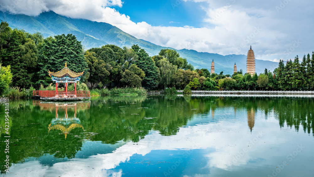 Scenic panorama of reflection park pond with the Three Pagodas and Cangshan mountains in background Dali Yunnan China