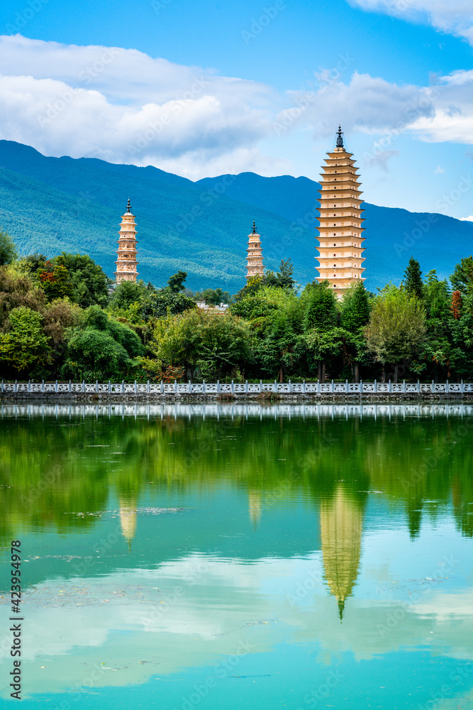 Vertical view of Dali Three Pagodas of Chongsheng Temple with water reflection and blue sky Dali Yunnan China