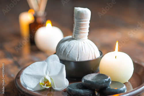 Spa background. Towel  candles  flowers  aroma sticks  massaging stones and herbal balls. Massage  oriental therapy  wellbeing and meditation.